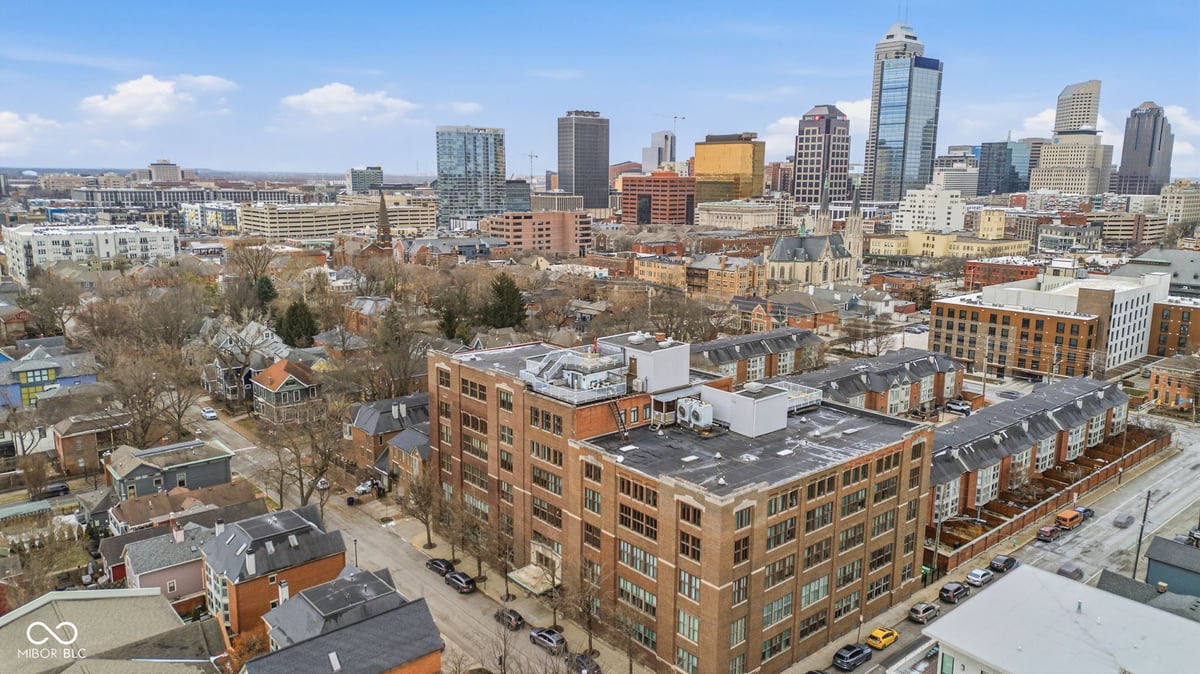 Aerial view of urban neighborhood with downtown Indianapolis skyline in the background
